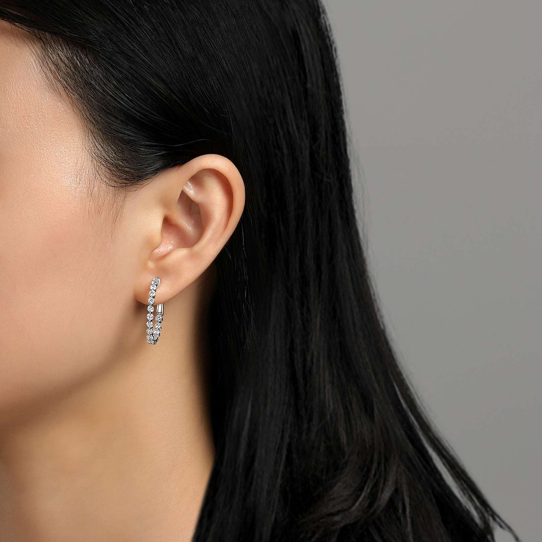 Classic hoops for every occasion. These inside out hoop earrings are set with Lafonn's signature Lassaire simulated diamonds in sterling silver bonded with platinum. 25 mm diameter.