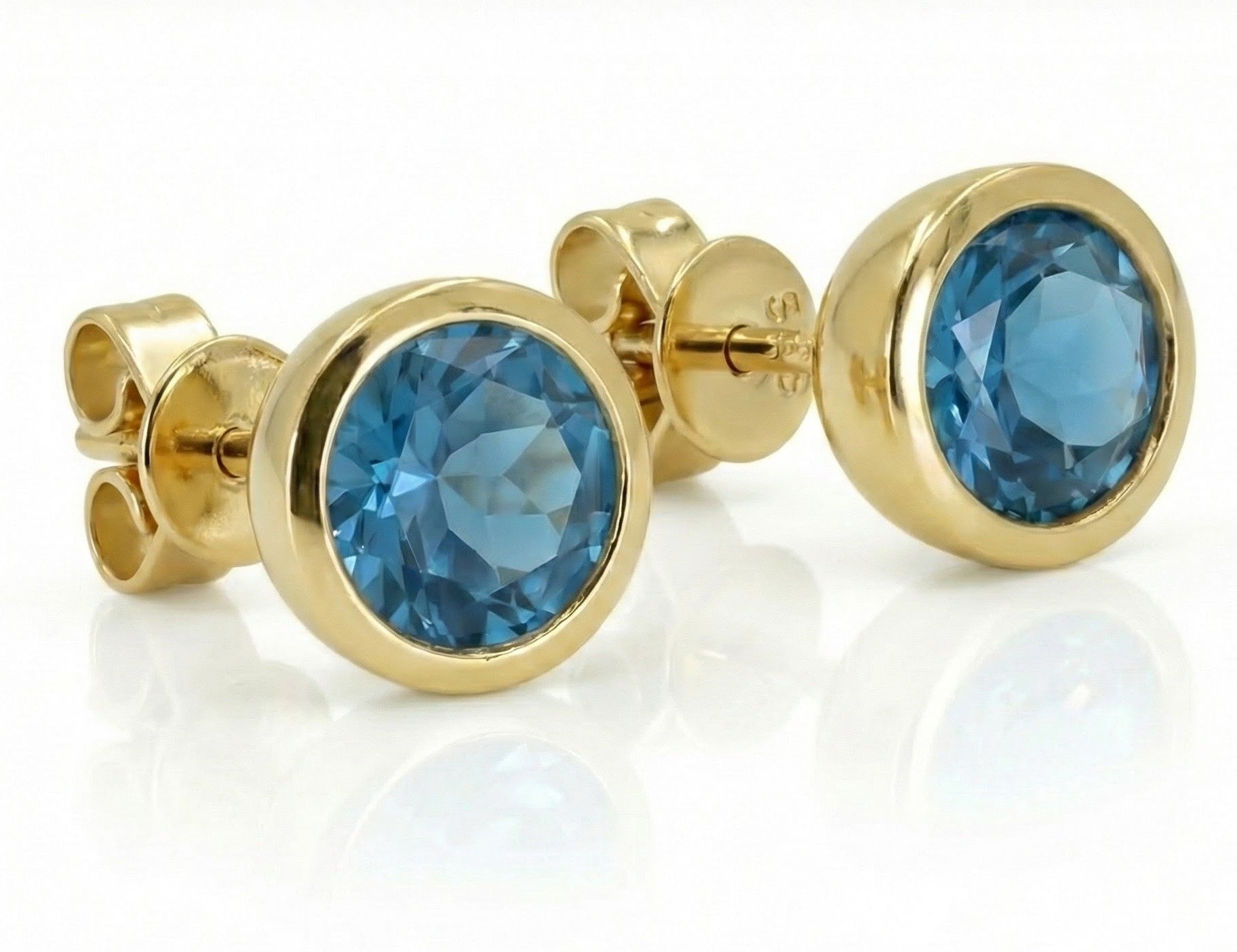 Madison L | Blue Topaz Stud Earrings | 14K Yellow Gold | Bezel-Set Round Gemstone Studs - Brownee Jewelers