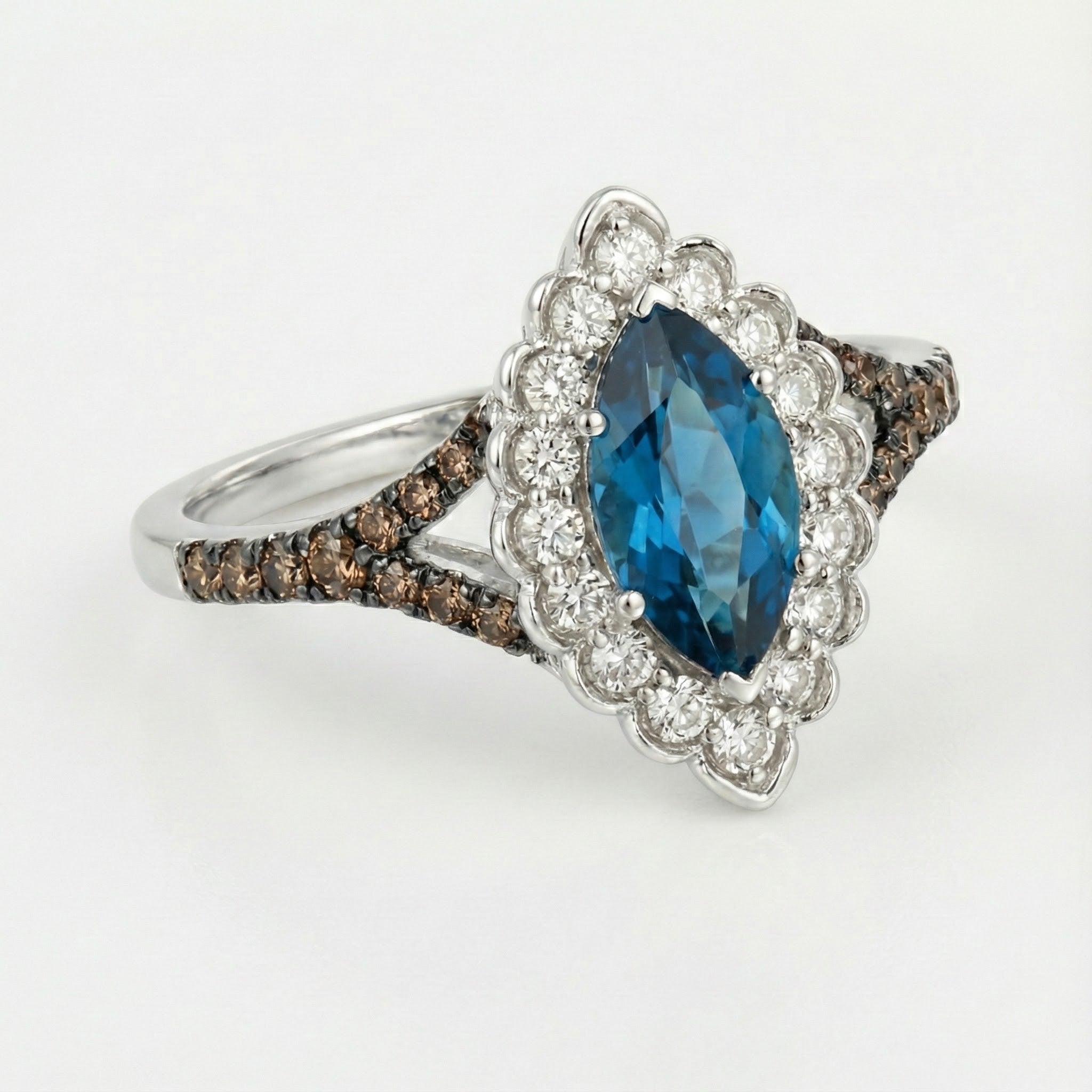 Le Vian® 14K Vanilla Gold® Deep Sea Blue Topaz™ & Chocolate/Nude Diamond® Ring (1.45ctw) Bold color meets elegant sparkle in this stunning Le Vian® ring featuring a vibrant 1 ct. Deep Sea Blue Topaz™ in an elongated marquise cut