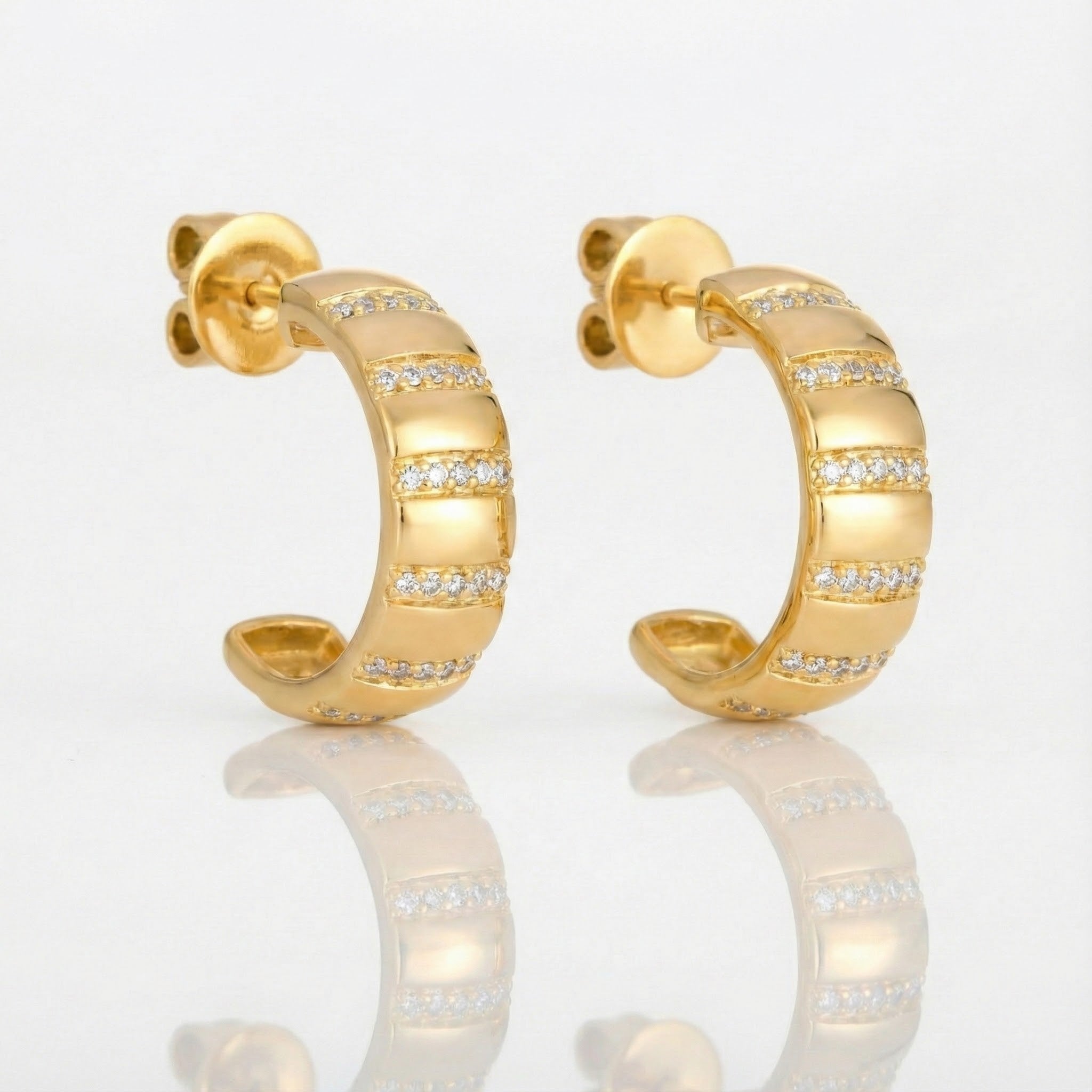 Le Vian® Vanilla Diamond® Huggie Earrings in 14K Honey Gold™ Chic, modern, and effortlessly luxurious, these Le Vian® huggie earrings feature 1/5 cts. of Vanilla Diamonds® set in sleek alternating rows along a sculpted 14K Honey Gold™ design
