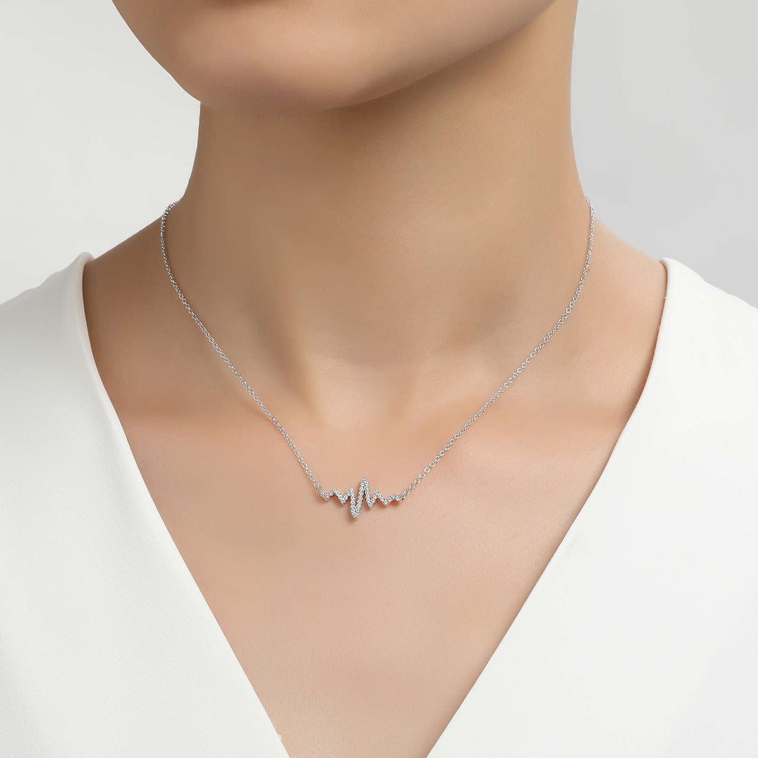 Playful and romantic. This heartbeat necklace is set with Lafonn's signature Lassaire clear simulated diamonds in sterling silver bonded with platinum.