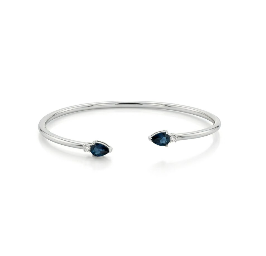 Blue Sapphire Bangle Bracelet | 10K White Gold | Pear-Cut Sapphire & Diamond Accent Open Bangle | .95 CTW Sapphire & .06CTW Diamonds - Brownee Jewelers
