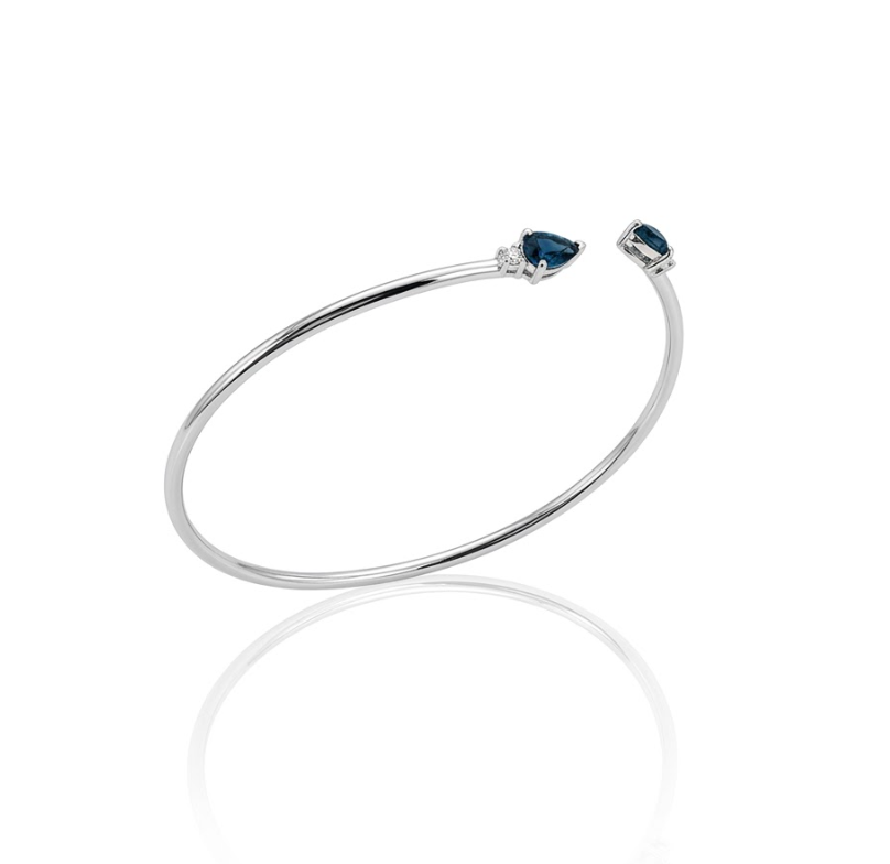 Blue Sapphire Bangle Bracelet | 10K White Gold | Pear-Cut Sapphire & Diamond Accent Open Bangle | .95 CTW Sapphire & .06CTW Diamonds - Brownee Jewelers