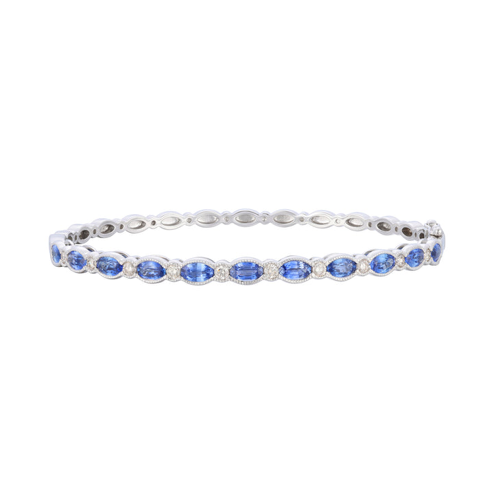 2.97 TOTAL CARAT WEIGHT OVAL SHAPED BLUE SAPPHIRE AND .40 TOTAL CARAT ROUND DIAMOND BEZEL BANGLE IN 14K WHITE GOLD