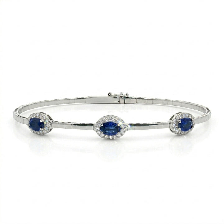 Blue Sapphire Halo Bangle | 14K White Gold | Oval Blue Sapphire & Diamond Bangle Bracelet | 1.48CT Sapphire & .25CT Diamond Accent - Brownee Jewelers