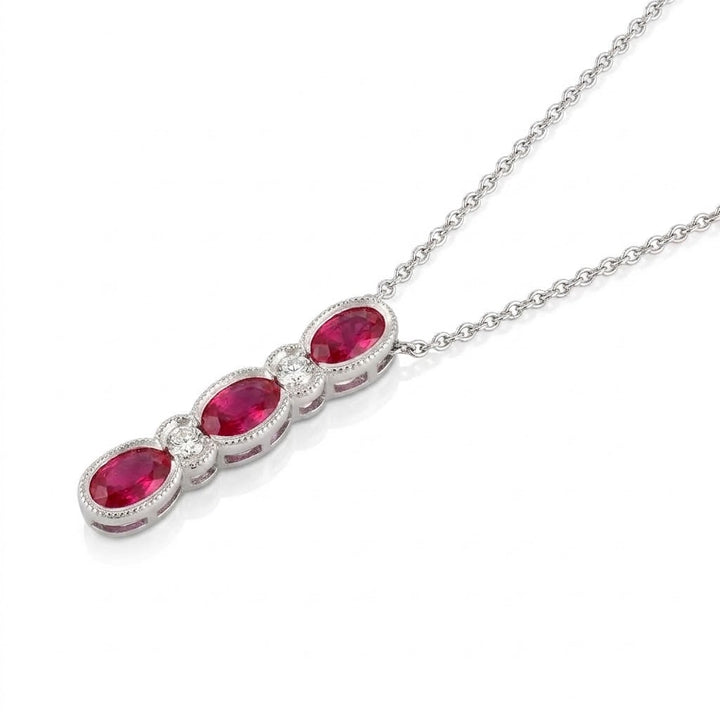 .78 TOTAL CARAT WEIGHT OVAL RUBY AND .08 TOTAL CARAT WEIGHT ROUND DIAMOND BEZEL DROP PENDANT IN 14K WHITE GOLD