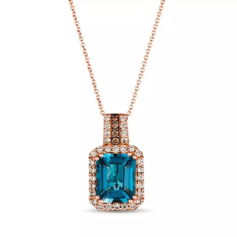 Le Vian® 14K Strawberry Gold® Deep Sea Blue Topaz™ & Nude Diamond™ Pendant (3.88ctw) Bold, vibrant, and luxuriously detailed—this Le Vian® pendant showcases a breathtaking 3 1/2 ct. Deep Sea Blue Topaz™ framed by 3/8 cts. of sparkling Nude Diamonds™