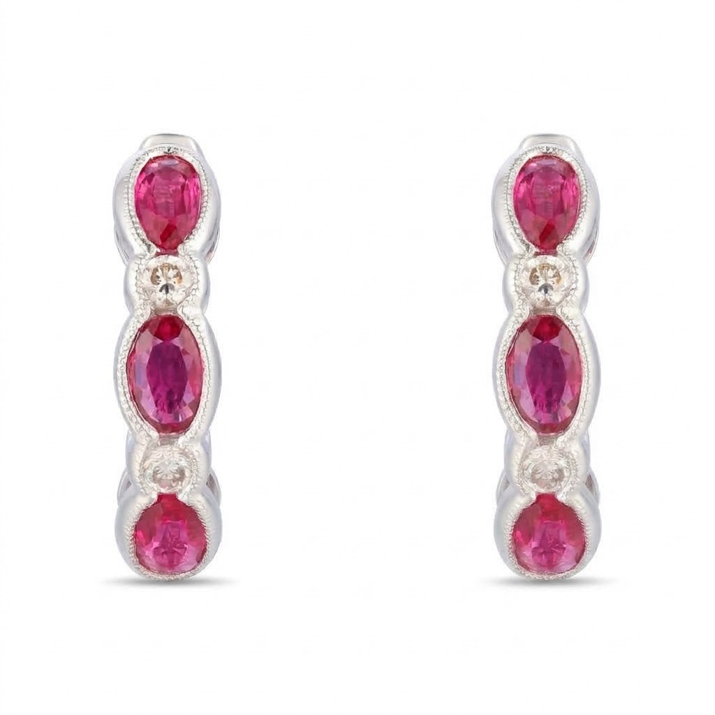 1.56 TOTAL CARAT WEIGHT OVAL RUBY AND .16 TOTAL CARAT WEIGHT ROUND DIAMOND BEZEL HUGGIE EARRINGS IN 14K WHITE GOLD